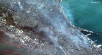 FILE - This satellite image provided by Maxar Technologies shows a view of port facilities and buildings on fire in western Mariupol, Ukraine, April 9, 2022. (Satellite image ©2022 Maxar Technologies via AP, File)