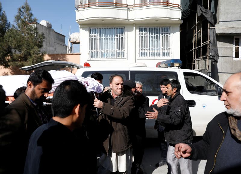 Relatives carry the body of one of the female judges shot dead by unknown gunmen in Kabul