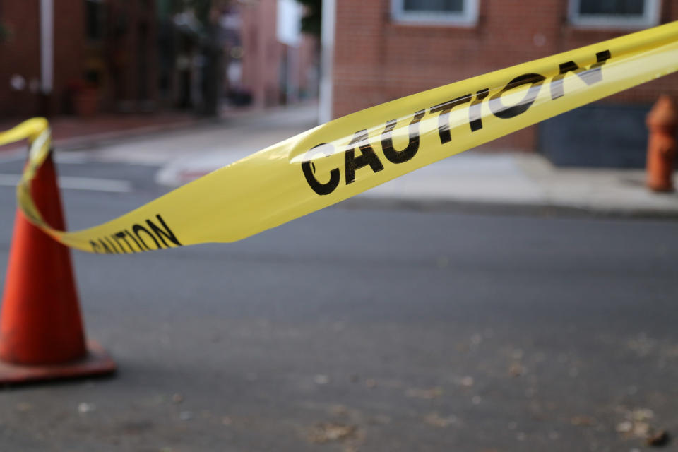 Caution tape alongside a crime scene