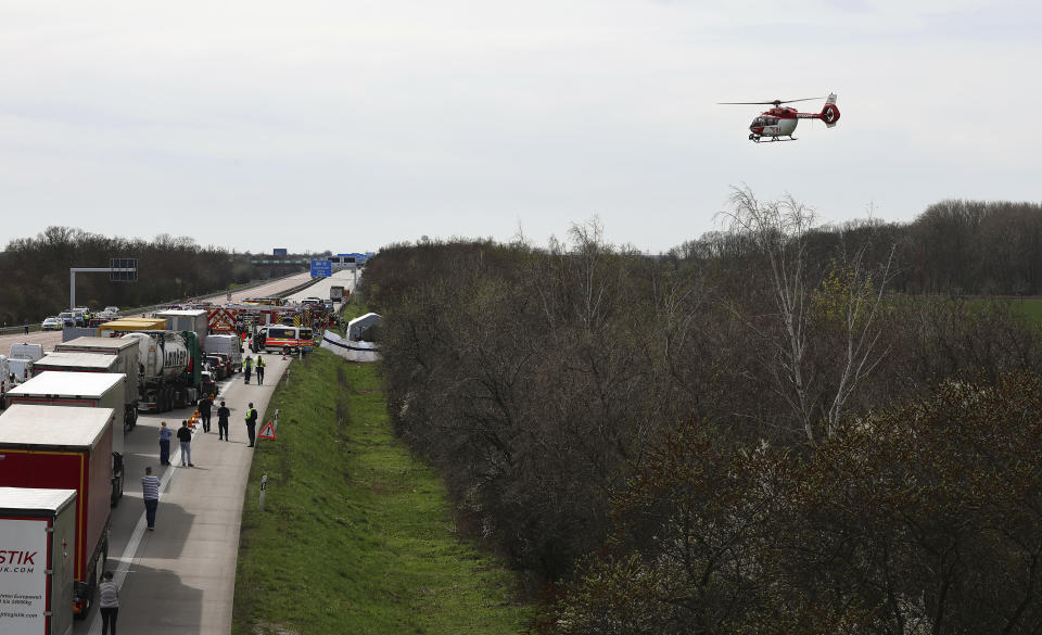 Emergency vehicles and a rescue helicopter work at the scene of the accident on the A9, near Schkeuditz, Germany, Wednesday, March 27. 2024. (Jan Woitas/dpa via AP)