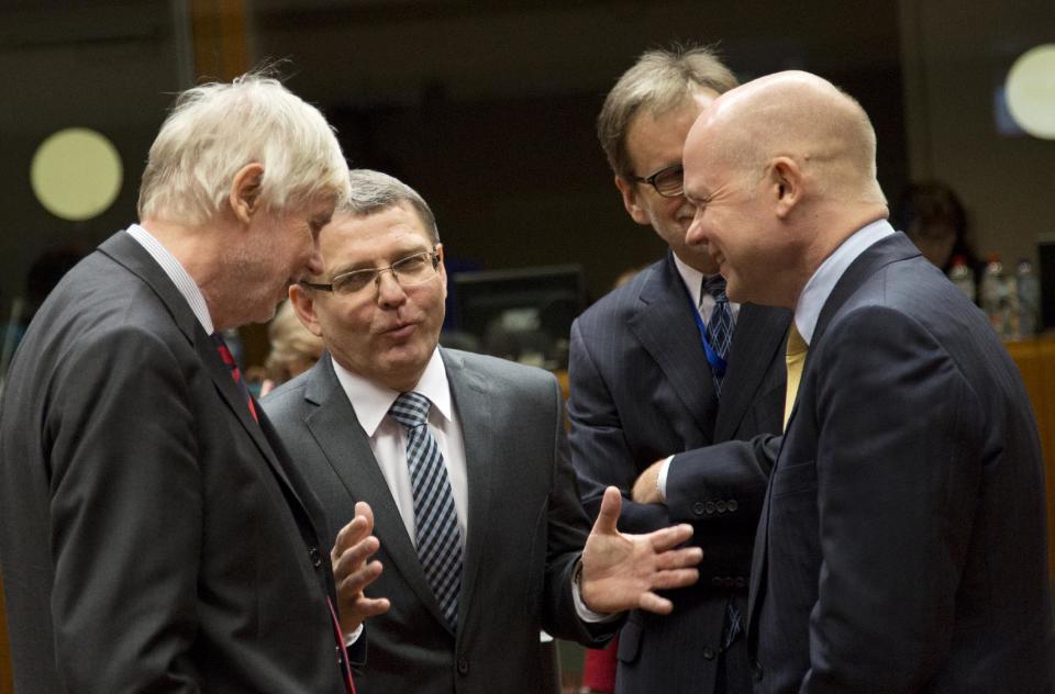 British Foreign Minister William Hague, right, speaks with from Finnish Foreign Minister Erkki Tuomioja, left, and Czech Republic's Foreign Minister Lubomir Zaoralek during a meeting of EU foreign ministers in Brussels on Monday, Feb. 10, 2014. EU foreign ministers on Monday will discuss how to help foster a political situation for the severe crisis that has engulfed Ukraine. The 28 ministers were also weighing the fallout of Sunday’s referendum in Switzerland putting into question the free movement of citizens between the bloc and the Alpine nation. (AP Photo/Virginia Mayo)