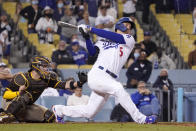 Los Angeles Dodgers' Corey Seager, right, hits a two-run home run as San Diego Padres catcher Victor Caratini watches during the eighth inning of a baseball game Wednesday, Sept. 29, 2021, in Los Angeles. (AP Photo/Mark J. Terrill)