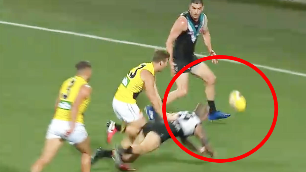 Port Adelaide's Hamish Hartlett is seen deliberately knocking the ball out of bounds against Richmond.