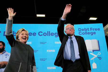 U.S. Democratic presidential nominee Hillary Clinton and U.S. Senator Bernie Sanders take the stage to talk about college affordability during a campaign event at the University of New Hampshire in Durham, New Hampshire, United States September 28, 2016. REUTERS/Brian Snyder