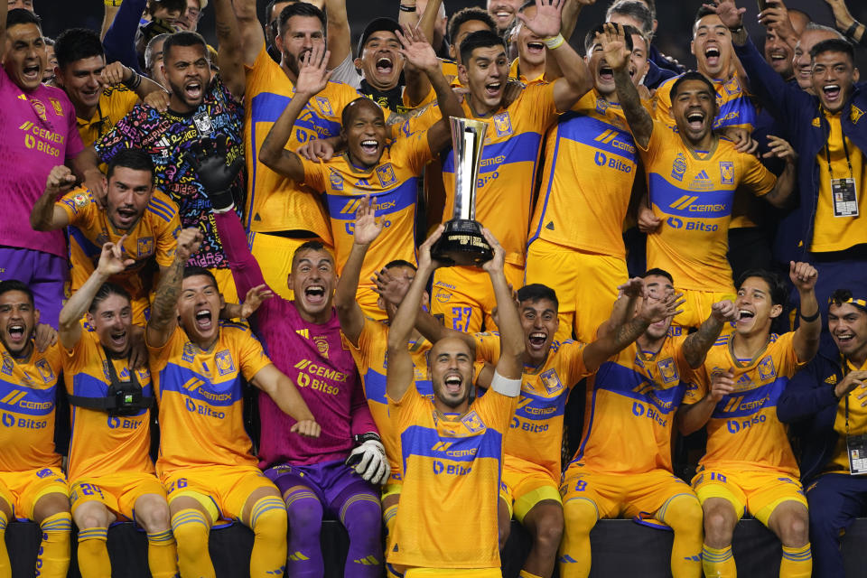 The Tigres team members cheer as midfielder Guido Pizarro, center, holds up the trophy after the team's 4-2 penalty kick win over Los Angeles FC during a Campeones Cup soccer match Wednesday, Sept. 27, 2023, in Los Angeles. (AP Photo/Ryan Sun)