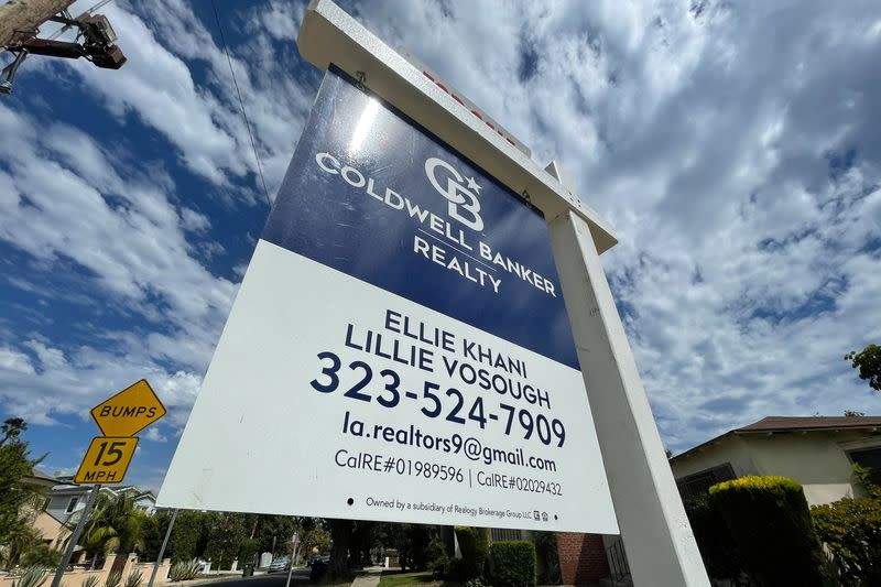 A real estate sign is seen outside a home in Los Angeles