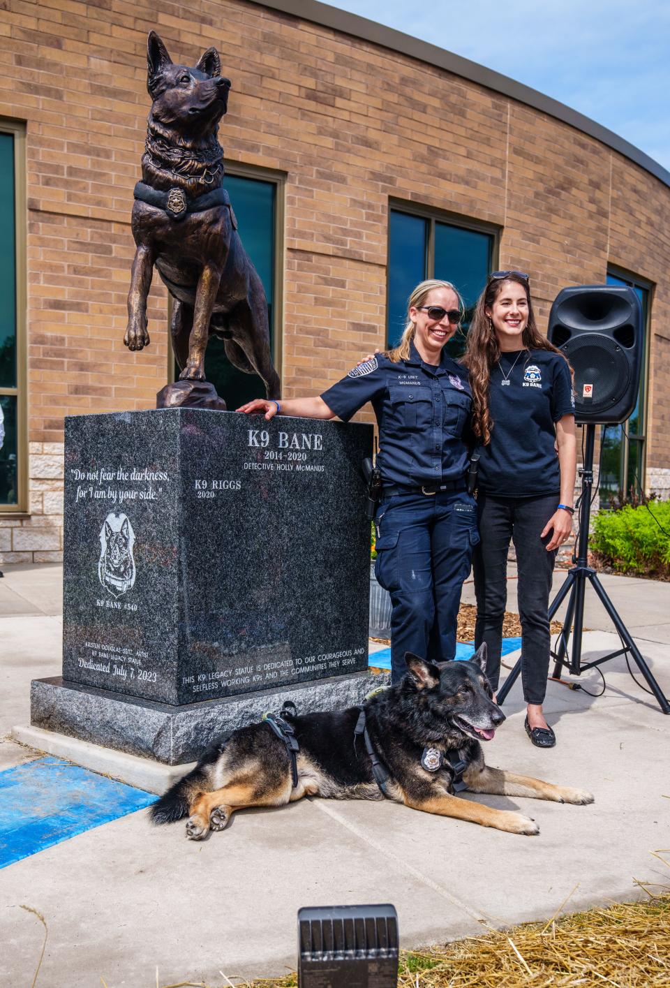 St. Francis Police Detective Holly McManus and her retired K9 partner Bane, pose for photos with sculptor Kristen Douglas-Seitz and the newly unveiled K9 Legacy Statue at St. Francis Police Department on Friday, July 7, 2023. The life-size bronze statue of retired K9 Officer Bane honors his life and service along with former and future K9 Officers serving the community.