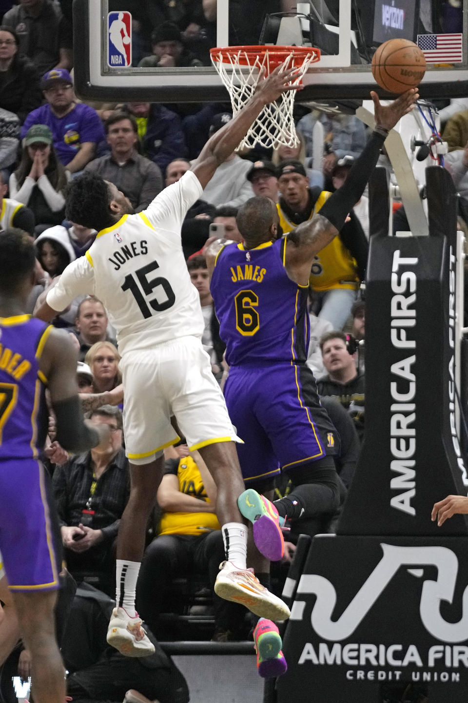 Los Angeles Lakers forward LeBron James (6) scores as Utah Jazz center Damian Jones (15) defends during overtime in an NBA basketball game Tuesday, April 4, 2023, in Salt Lake City. (AP Photo/Rick Bowmer)