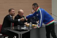 Captain of The Vatican soccer team Filippo Montimurri, right, greets Lazio soccer team striker Ciro Immobile during the presentation of the soccer match between the Vatican soccer team "Fratelli Tutti" (All Brothers) and the World Rom Organization team, at the Vatican, Tuesday, Nov. 16, 2021. The match will be played Sunday, Nov. 21, at the Lazio training ground of Formello. (AP Photo/Gregorio Borgia)