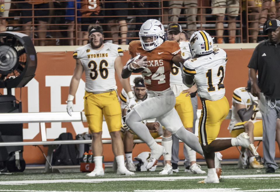 Texas running back Jonathon Brooks (24) carries past Wyoming's Chauncey Carter (12) during the first half of an NCAA college football game Saturday, Sept. 16, 2023, in Austin, Texas. (AP Photo/Michael Thomas)