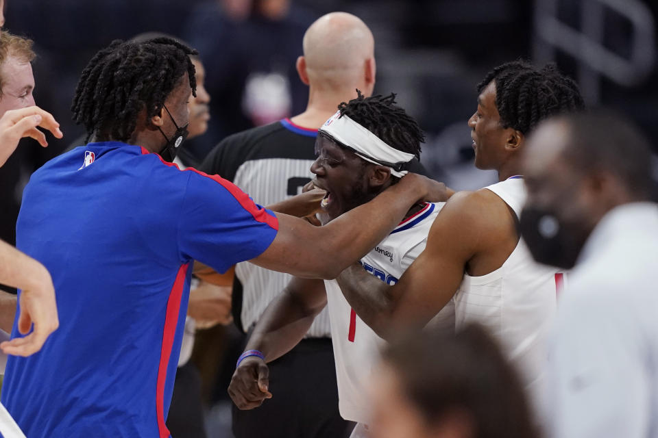 Los Angeles Clippers guard Reggie Jackson (1) is surrounded by teammates after hitting the game winning basket during the second half of an NBA basketball game against the Detroit Pistons, Wednesday, April 14, 2021, in Detroit. (AP Photo/Carlos Osorio)