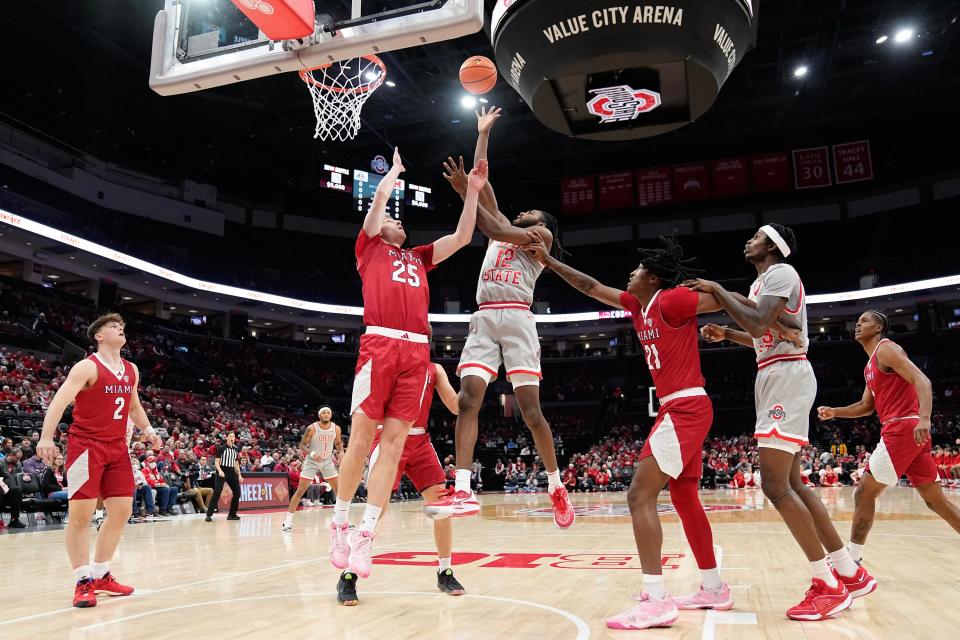 Dec 6, 2023; Columbus, OH, USA; Ohio State Buckeyes guard Evan Mahaffey (12) shoots over Miami Redhawks forward Bryce Bultman (25) during the first half of the NCAA men’s basketball game at Value City Arena.