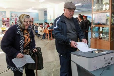 People vote at a polling station during the presidential election in Bishkek, Kyrgyzstan October 15, 2017. REUTERS/Vladimir Pirogov