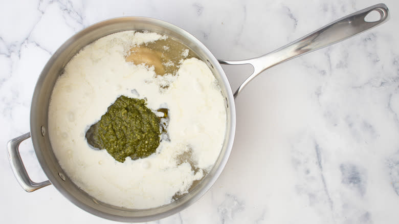 cream and pesto in saucepan