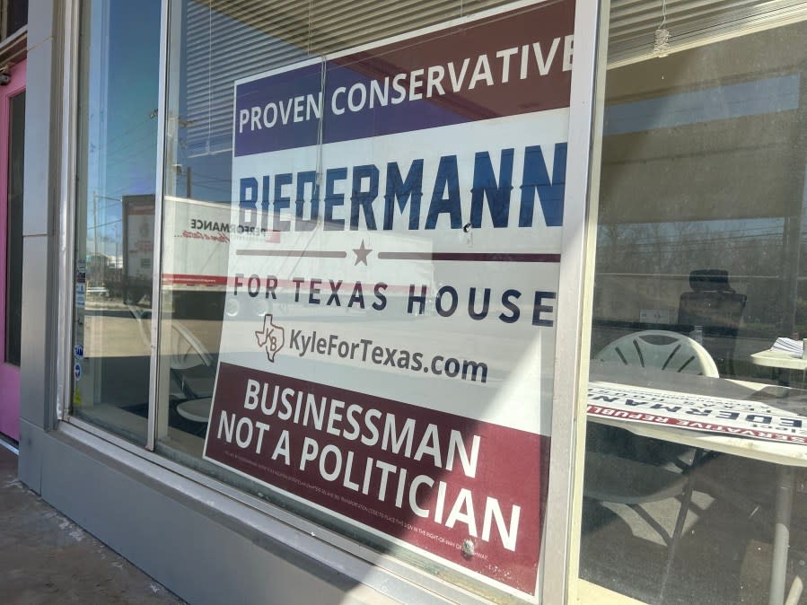 A campaign sign for Kyle Biedermann sits in the window of a building in Fredericksburg. (KXAN photo/Will DuPree)
