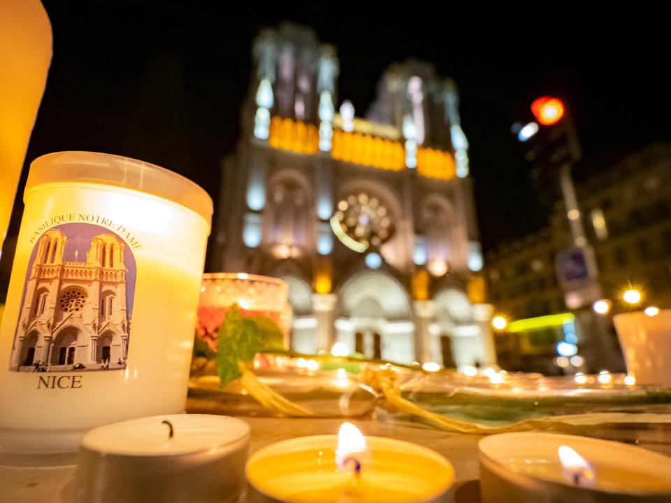 People pay tribute at night in front of Notre Dame Basilica on October 29, 2020 in Nice, FranceGetty Images