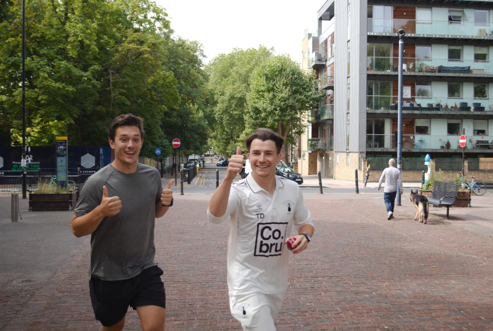 Man gives a thumbs up to the camera whilst running