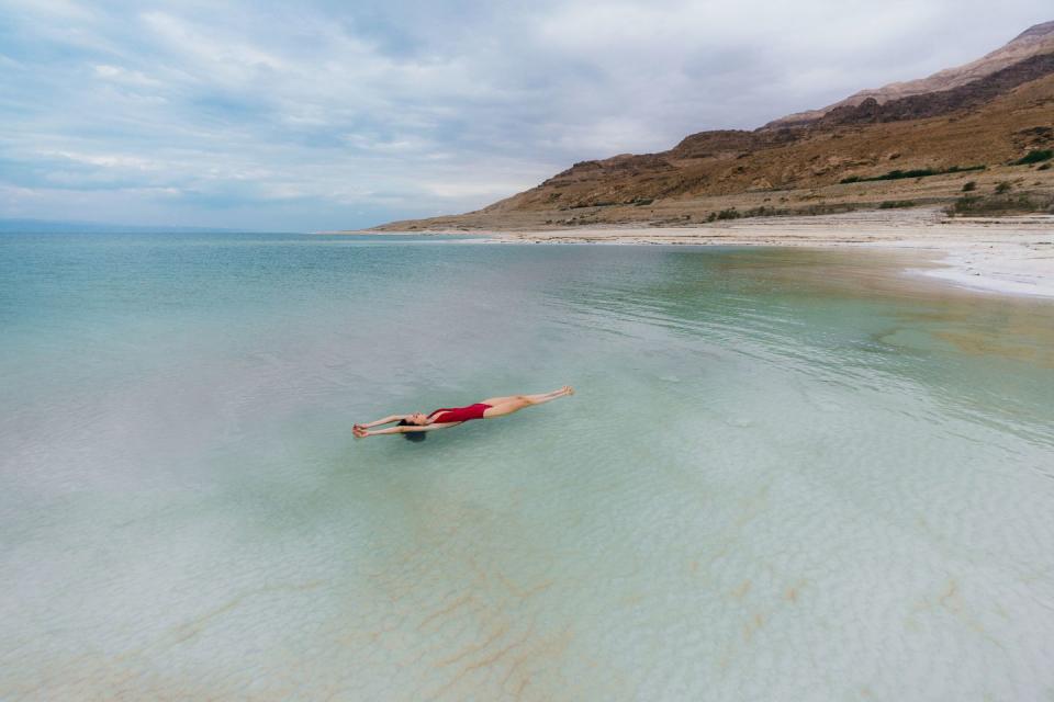 Woman floating on water  in Dead Sea