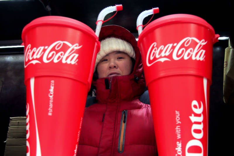 A woman sells giant Coca-Cola drinks at a road-side store in Beijing on January 25, 2015. On March 29, 1886, Coca-Cola was created by Dr. John Pemberton, who produced it in his backyard in Atlanta. File Photo by Stephen Shaver/UPI