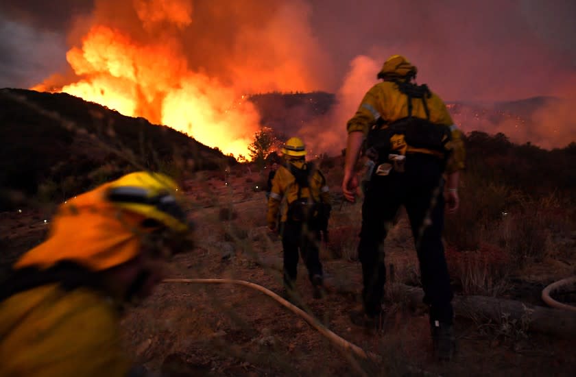 YUCAIPA, CALIFORNIA SEPTEMBER 1, 2020-Firefighters make they there way up a hill as the El Dorado Fire appriaches in Yucaipa Saturday.(Wally Skalij/Los Angeles Times)