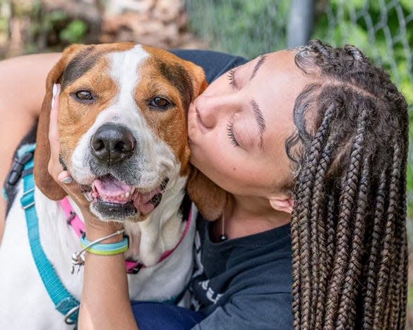 Nevaeh Rice kisses "Lady," one of the dogs available for adoption at Madison County Animal Services.