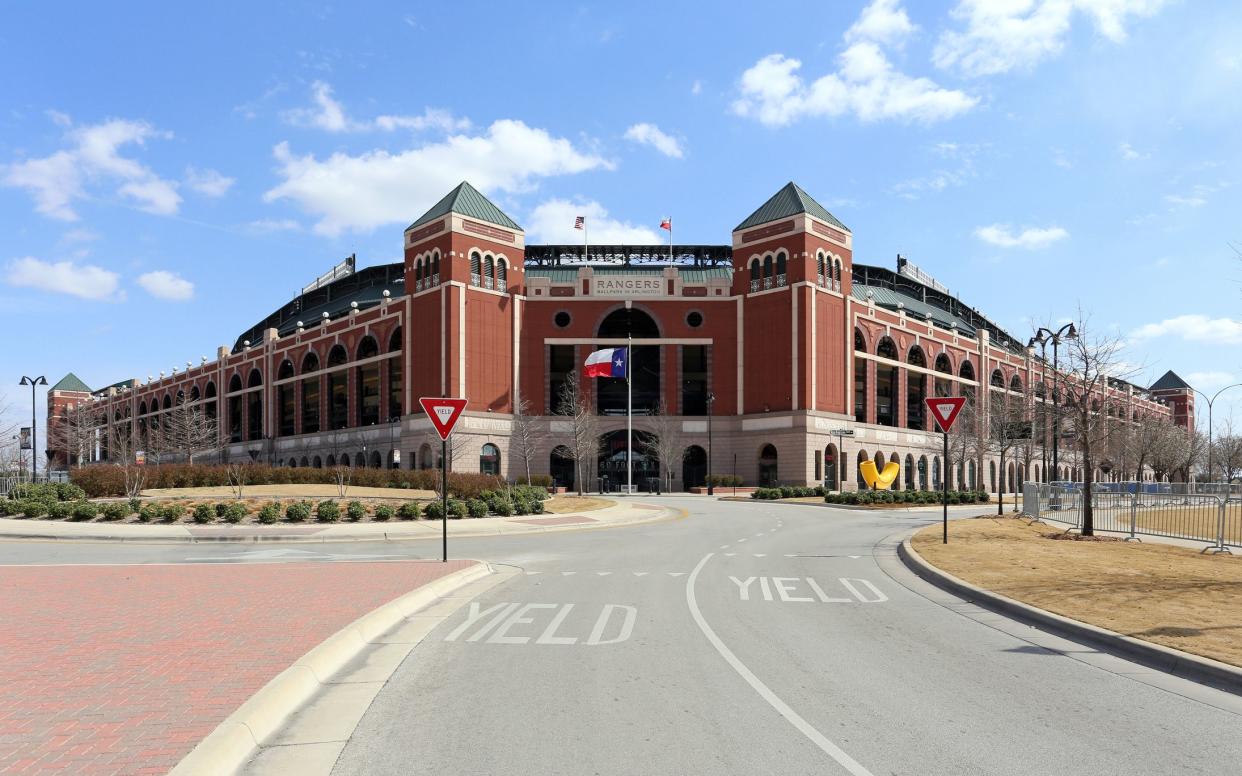 Front exterior of Choctaw Stadium, Arlington, Texas, home of the Texas Rangers with 'Yield' on road leading up to the stadium