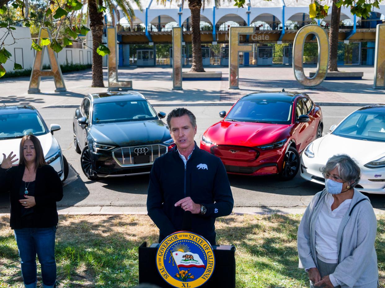 Gavin Newsom speaks at a press conference on Wednesday, 23 September 2020, at Cal Expo in Sacramento where he announced an executive order requiring the sale of all new passenger vehicles to be zero-emission by 2035 ((Daniel Kim/Sacramento Bee via AP))