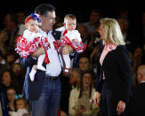 Ann Romney (R) reacts after her husband, Republican presidential candidate and former Massachusetts Governor Mitt Romney, brought babies from the audience onstage at a campaign rally in Knoxville, Tennessee March 4, 2012. REUTERS/Brian Snyder