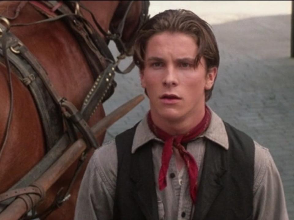 Christian Bale next to a horse in newsies
