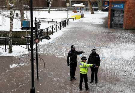Police officers stand at the cordon near the tent covering the park bench where former Russian intelligence officer Sergei Skripal and his daughter Yulia were found poisoned in Salisbury, Britain, March 19, 2018. REUTERS/Peter Nicholls
