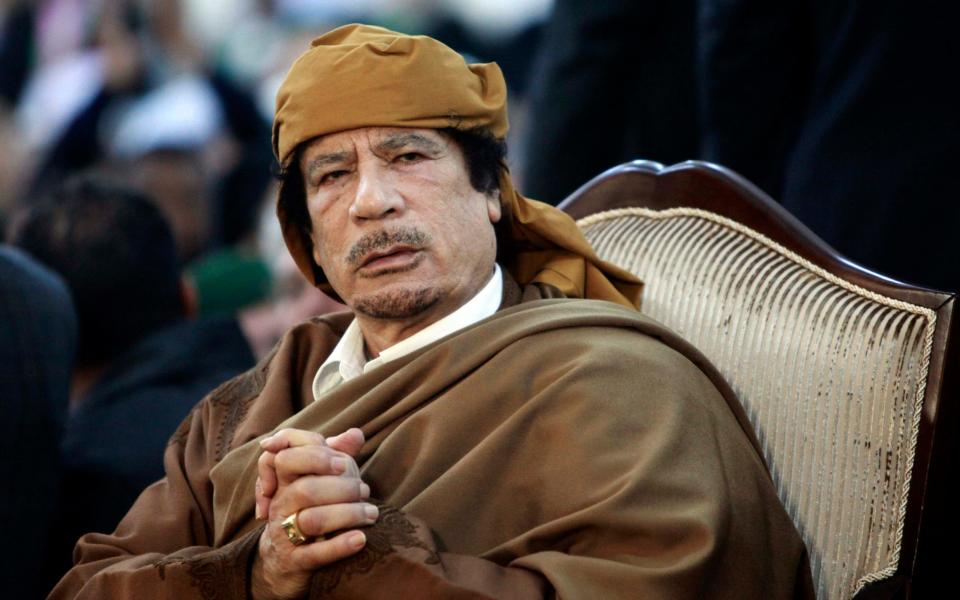  Libyan leader Muammar Gaddafi attending a ceremony marking the birth of Islam's Prophet Mohammed in Tripoli - Credit: Reuters