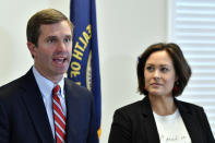 Kentucky Governor-Elect Andy Beshear, left, and his Lt. Governor Jacqueline Coleman speak with reporters following the concession of incumbent Governor Matt Bevin in Frankfort, Ky., Thursday, Nov. 14, 2019. In a recanvass, Beshear defeated Bevin by 5136 votes. (AP Photo/Timothy D. Easley)