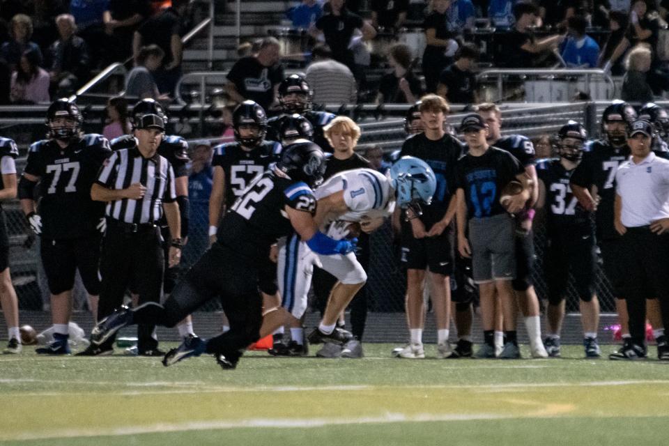 Central Bucks South linebacker Jim Wade tackles North Penn wide receiver Jackson Schurmann.