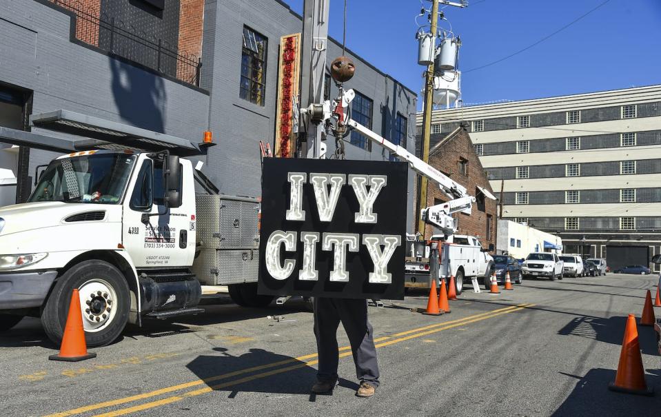 Urban redevelopment efforts can create more housing through projects such as turning warehouses into apartment buildings like this one in Washington, D.C. <a href="https://www.gettyimages.com/detail/news-photo/brian-dwyer-sign-technician-guides-an-ivy-city-sign-being-news-photo/496784922" rel="nofollow noopener" target="_blank" data-ylk="slk:Ricky Carioti/ The Washington Post via Getty Images;elm:context_link;itc:0;sec:content-canvas" class="link ">Ricky Carioti/ The Washington Post via Getty Images</a>