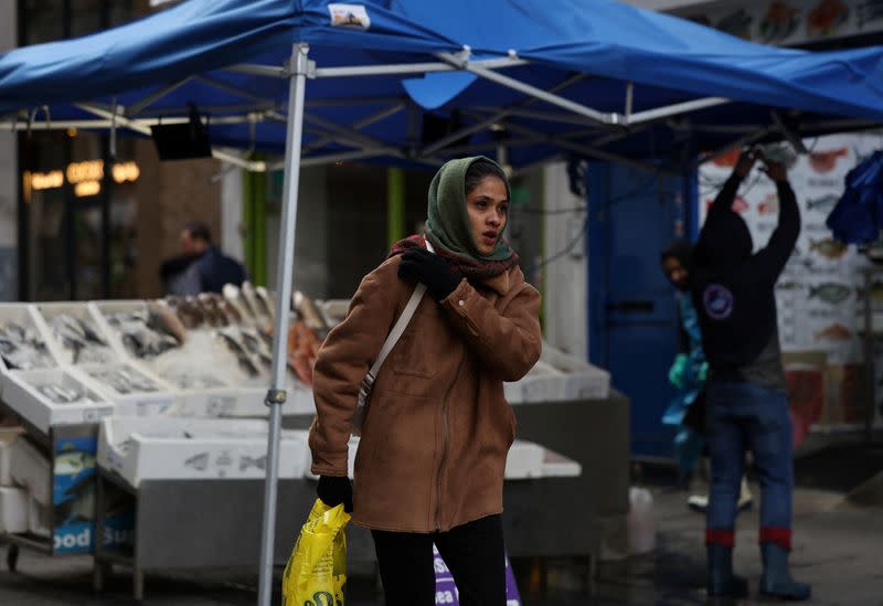 A woman walks through Surrey Street market in Croydon, south London
