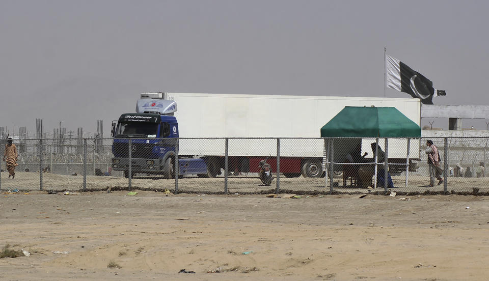 A delivery truck inbound for Afghanistan move towards the Afghan side at a border crossing point, in Chaman, Pakistan, Wednesday, Aug. 18, 2021. Chaman, is a key border crossing between Pakistan and Afghanistan, normally thousands of Afghans and Pakistanis cross daily and a steady stream of trucks passes through, taking goods to Afghanistan. (AP Photo/Jafar Khan)