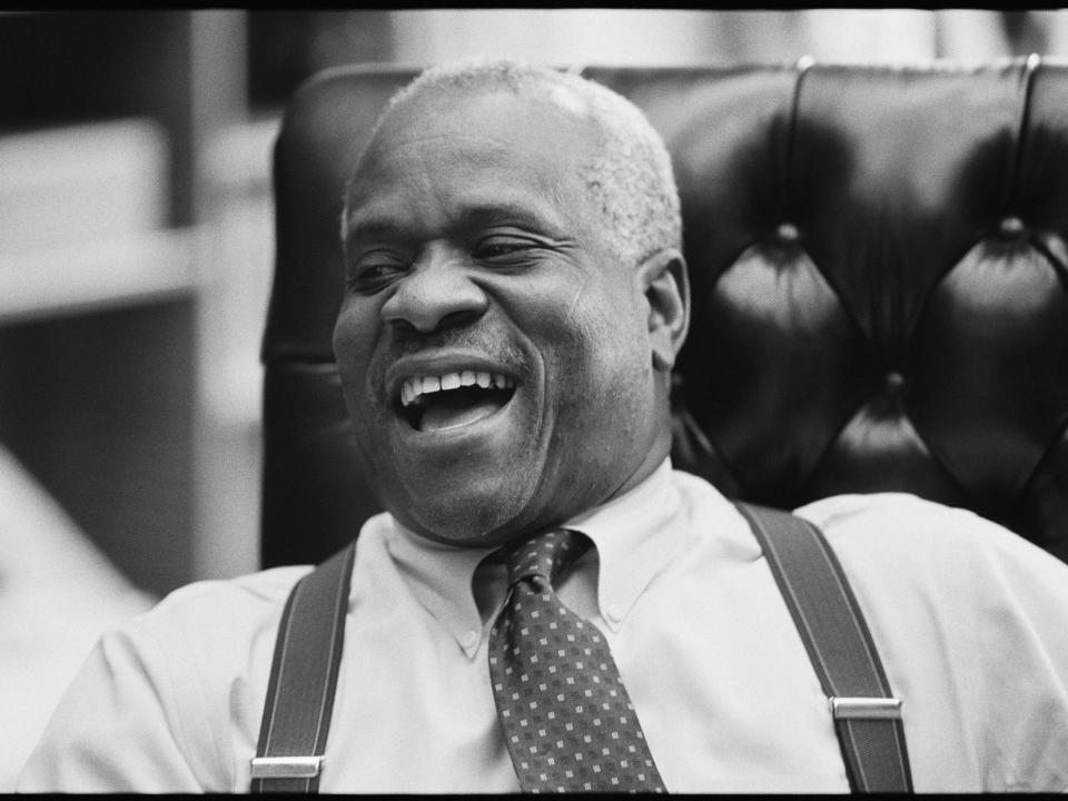 Supreme Court Justice Clarence Thomas laughs in his chambers at the Supreme Court