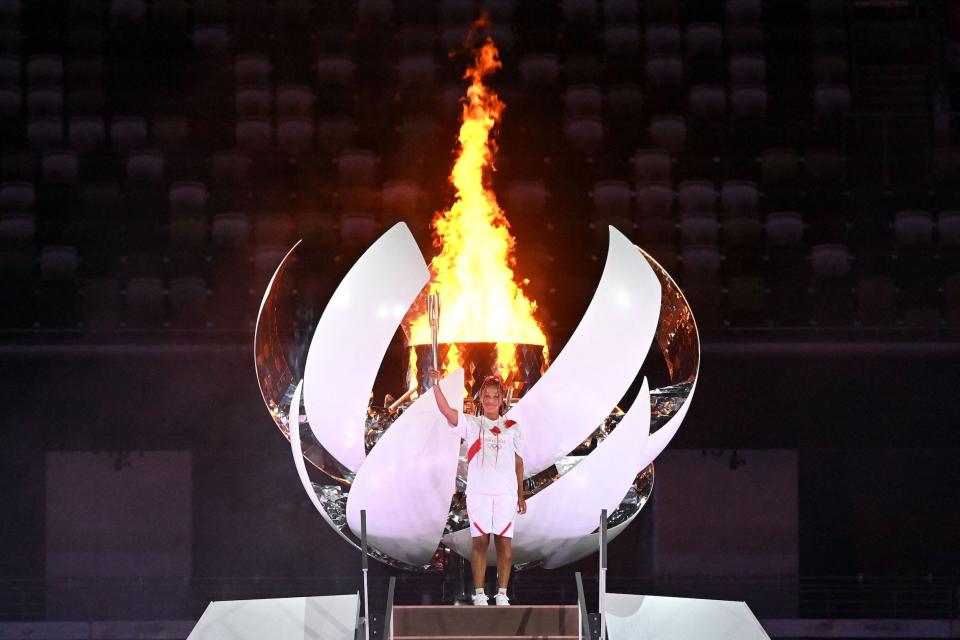 Japanese tennis player Naomi Osaka poses after lighting the Olympic Cauldron