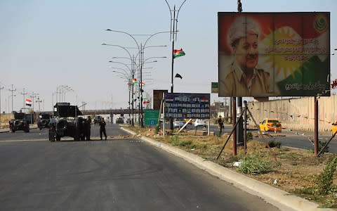 A banner showing an image of the Kurdish regional president Massoud Barzani, as Iraqi forces advance towards Kirkuk - Credit: Ahmad Al-Rubaye/AFP