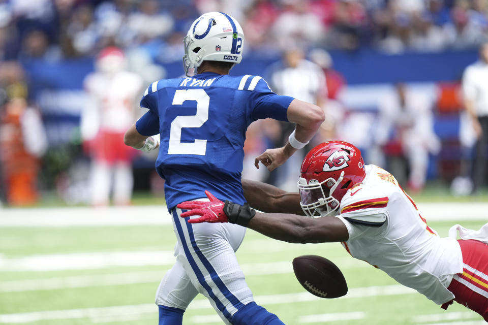 Indianapolis Colts quarterback Matt Ryan (2) fumbles as he is hit by Kansas City Chiefs defensive end Carlos Dunlap (8) during the first half of an NFL football game, Sunday, Sept. 25, 2022, in Indianapolis. (AP Photo/AJ Mast)