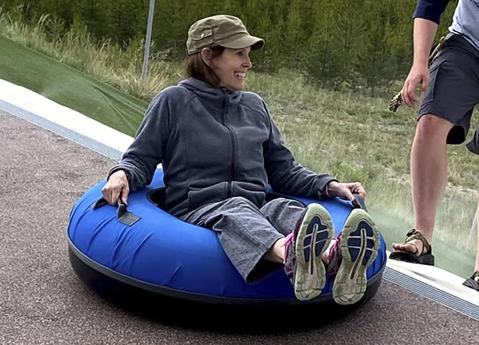 In this photo provided by Eden Ivie, Melody Ivie, of Farmington, N.M., rides a tube during a family vacation in Colorado in 2021. Melody Ivie, 73, was one of the people killed when a gunman opened fire on a busy street in Farmington on May 15, 2023. (Eden Ivie via AP)