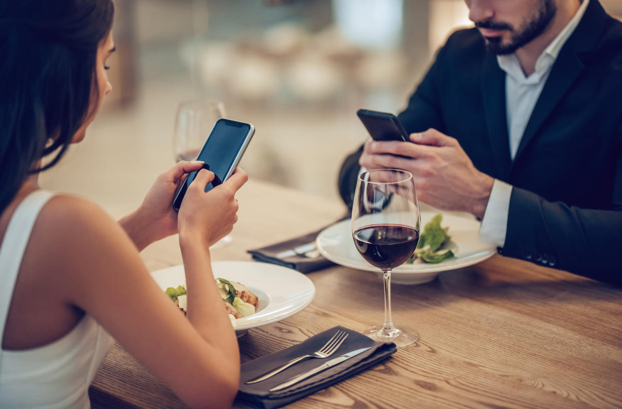 Using your phone on a date is another faux-pas. (Getty Images)