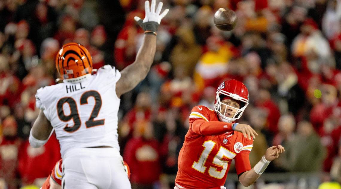 Kansas City Chiefs quarterback Patrick Mahomes (15) throws around the outstretched arm of Cincinnati Bengals defensive tackle BJ Hill (92) during an NFL football game at GEHA Field at Arrowhead Stadium on Sunday, Dec. 31, 2023, in Kansas City.