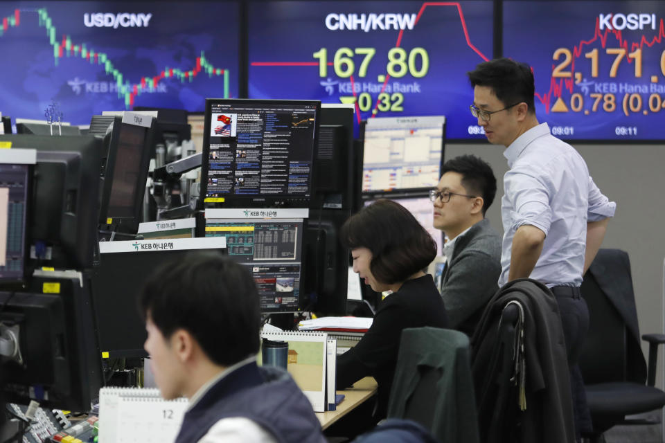 Currency traders work at the foreign exchange dealing room of the KEB Hana Bank headquarters in Seoul, South Korea, Monday, Dec. 16, 2019. Asian stock markets were mixed Monday following a U.S.-Chinese trade deal that disappointed some investors. (AP Photo/Ahn Young-joon)