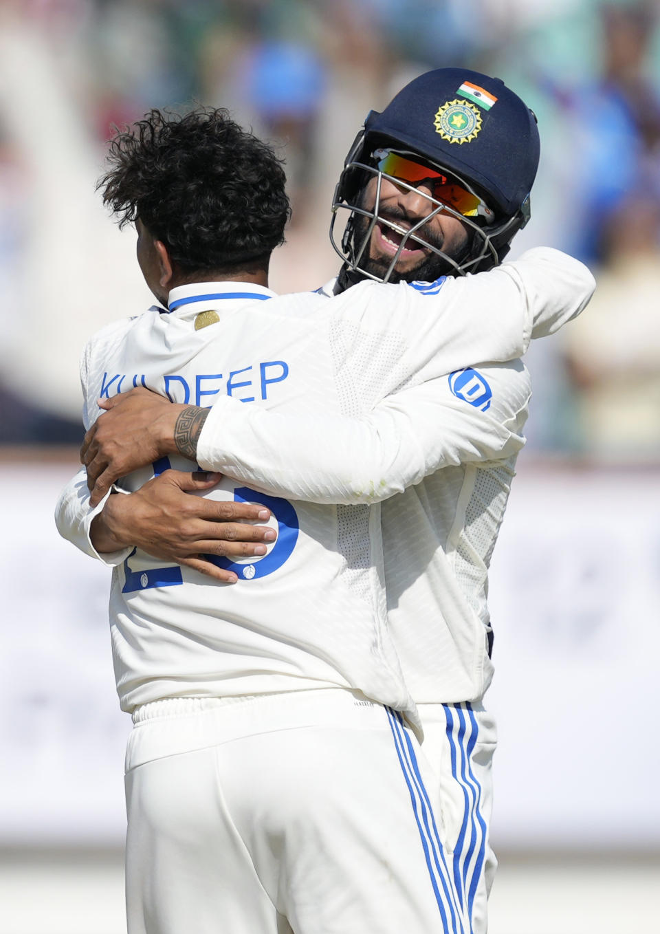 India's Kuldeep Yadav, left and Rajat Patidar celebrate the wicket of England's Rehan Ahmed on the fourth day of the third cricket test match between England and India in Rajkot, India, Sunday, Feb. 18, 2024. (AP Photo/Ajit Solanki)