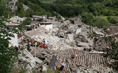 Rescuers work following an earthquake at Pescara del Tronto, central Italy, August 24, 2016. REUTERS/Remo Casilli
