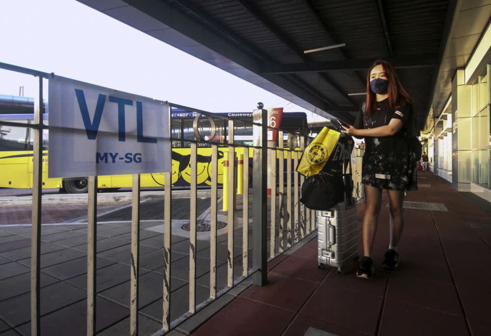 A woman waits to board a bus at the Larkin Sentral Bus Terminal in Johor Baru November 29, 2021. Johor DAP deputy chief Teo Nie Ching said this is in light of the limited number of people allowed to use the vaccinated-travel-lane (VTL), which lets Malaysians living in Singapore return home amid the Covid-19 pandemic. — Bernama pic