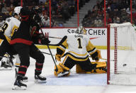 The puck goes into the net of Pittsburgh Penguins goaltender Casey DeSmith (1) on a shot by Ottawa Senators' Zach Sanford (not shown) during second period of an NHL hockey game in Ottawa, on Saturday, Nov. 13, 2021. (Justin Tang/The Canadian Press via AP)