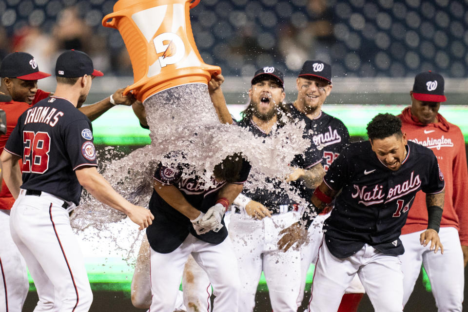 Washington Nationals' Jacob Young, center left, is doused with Gatorade by teammates after hitting a walk-off single during the ninth inning of a baseball game against the New York Mets, Wednesday, Sept. 6, 2023, in Washington. (AP Photo/Stephanie Scarbrough)