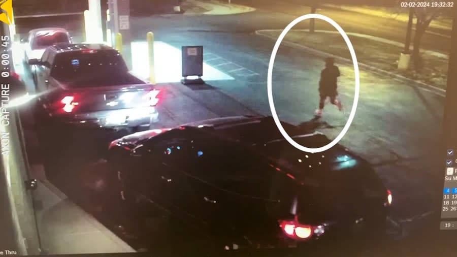 Nighttime surveillance video showing a man running down a street